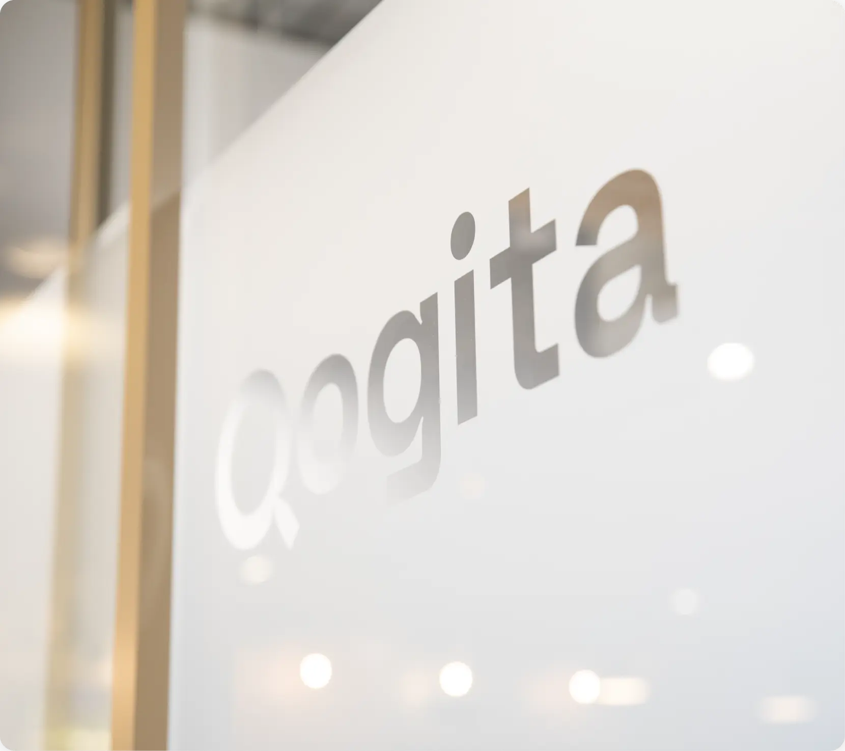 Qogita's name on a glass door